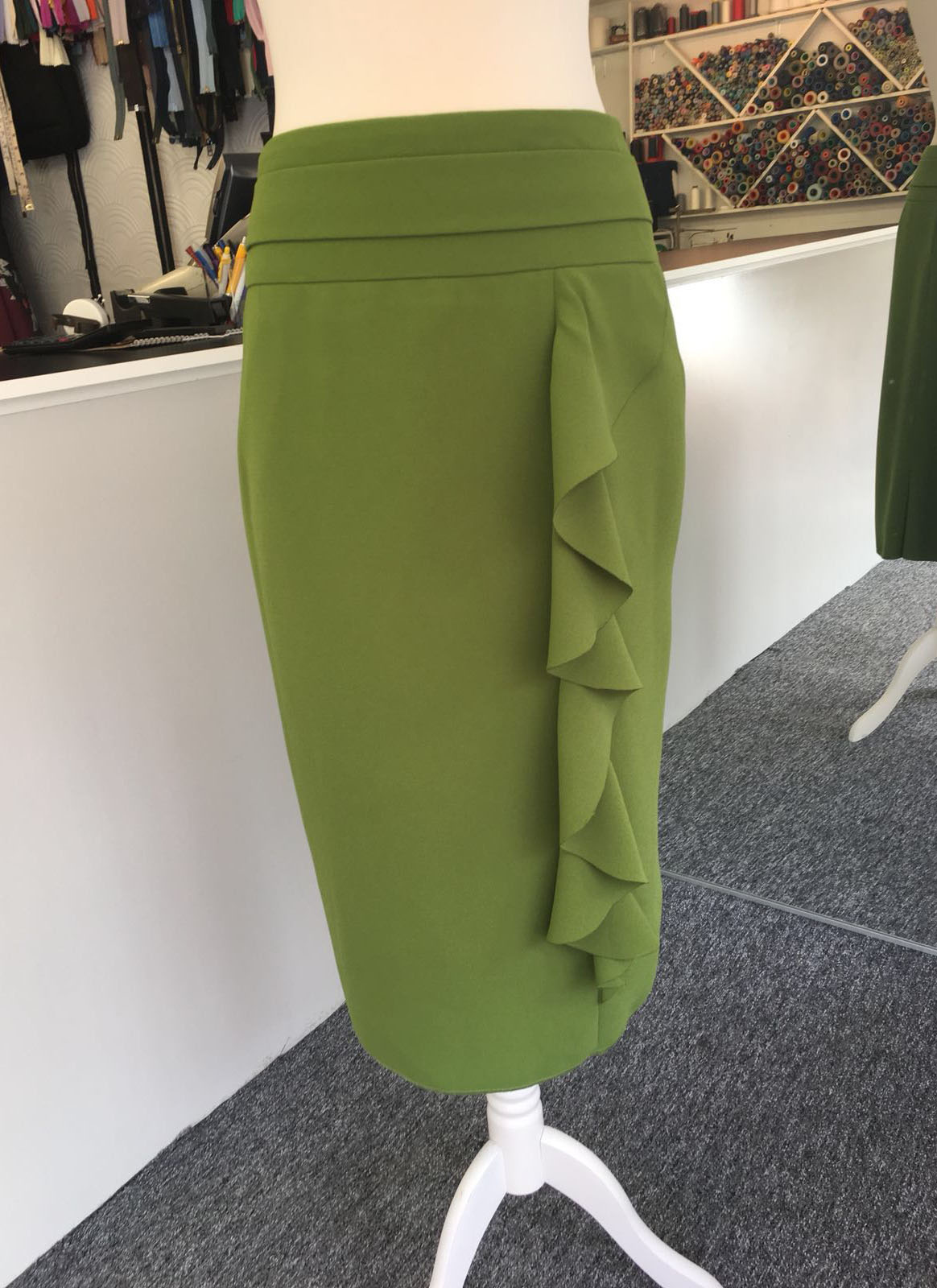 Olive green pencil skirt with cascading side ruffle detail